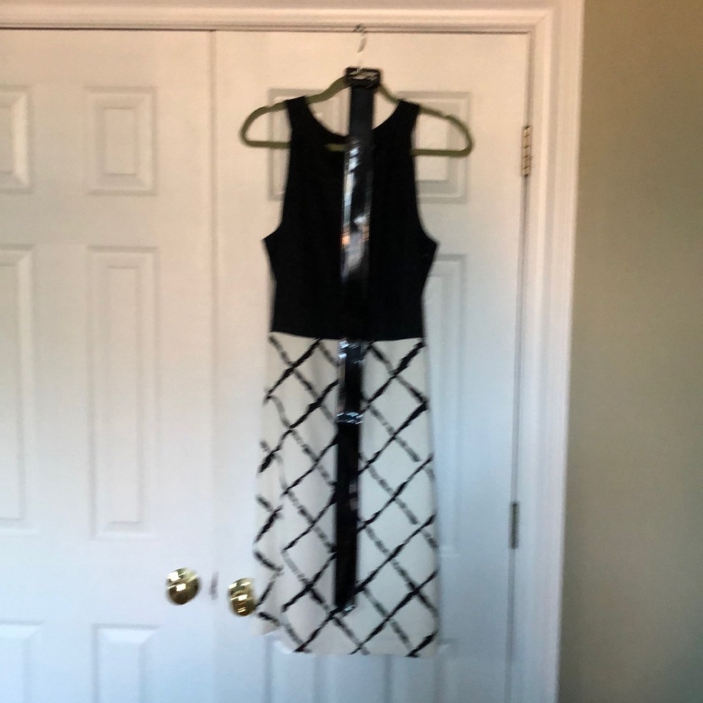 A line dress with patent leather belt